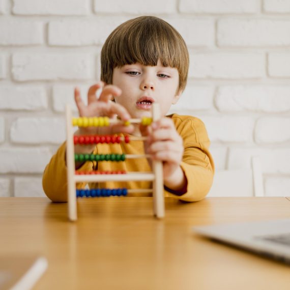 front-view-child-with-abacus-desk