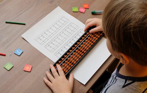 little-boy-doing-simple-math-exercises-with-abacus-scores-mental-arithmeric-view-from-shoulder_120794-635_11zon